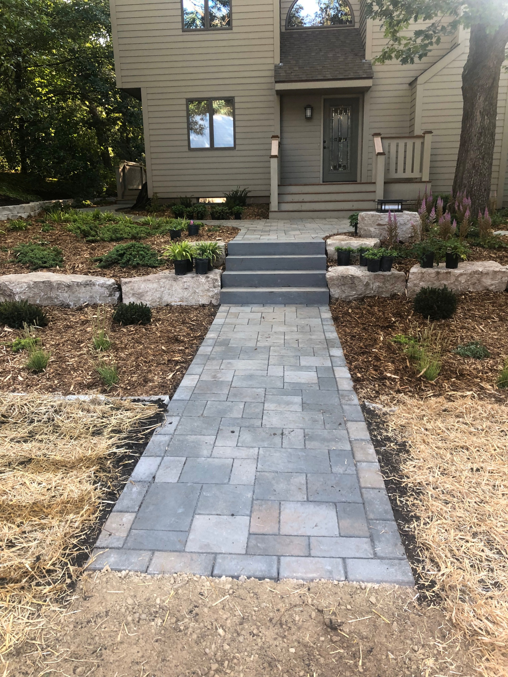 Choosing the Right Hardscape Materials A display of pavers, natural stone, and retaining wall blocks for hardscape project selection.