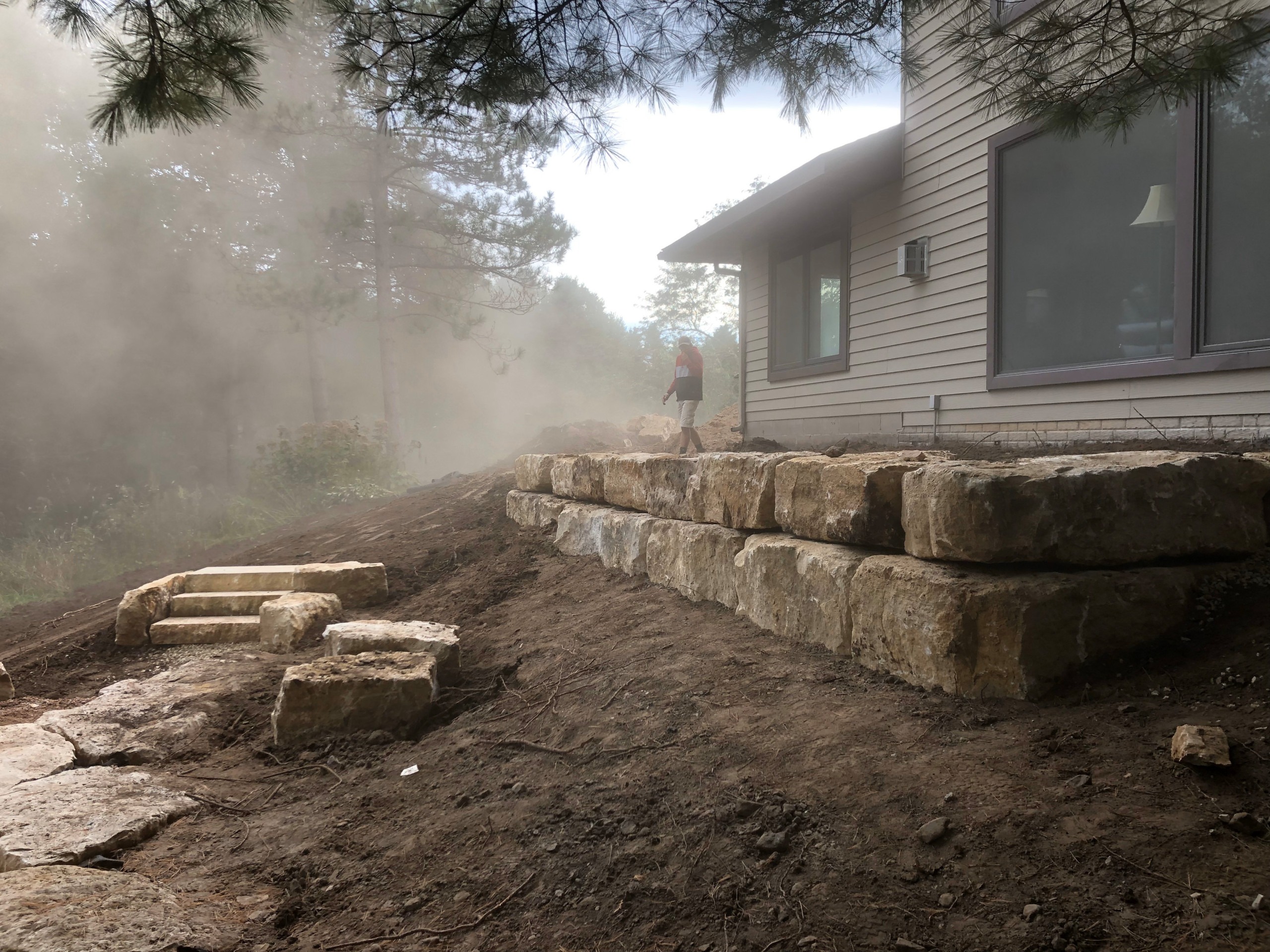 Spring Hardscape Installation – Get Ready for the Season Early spring hardscape project installation, featuring a paver patio in progress.
