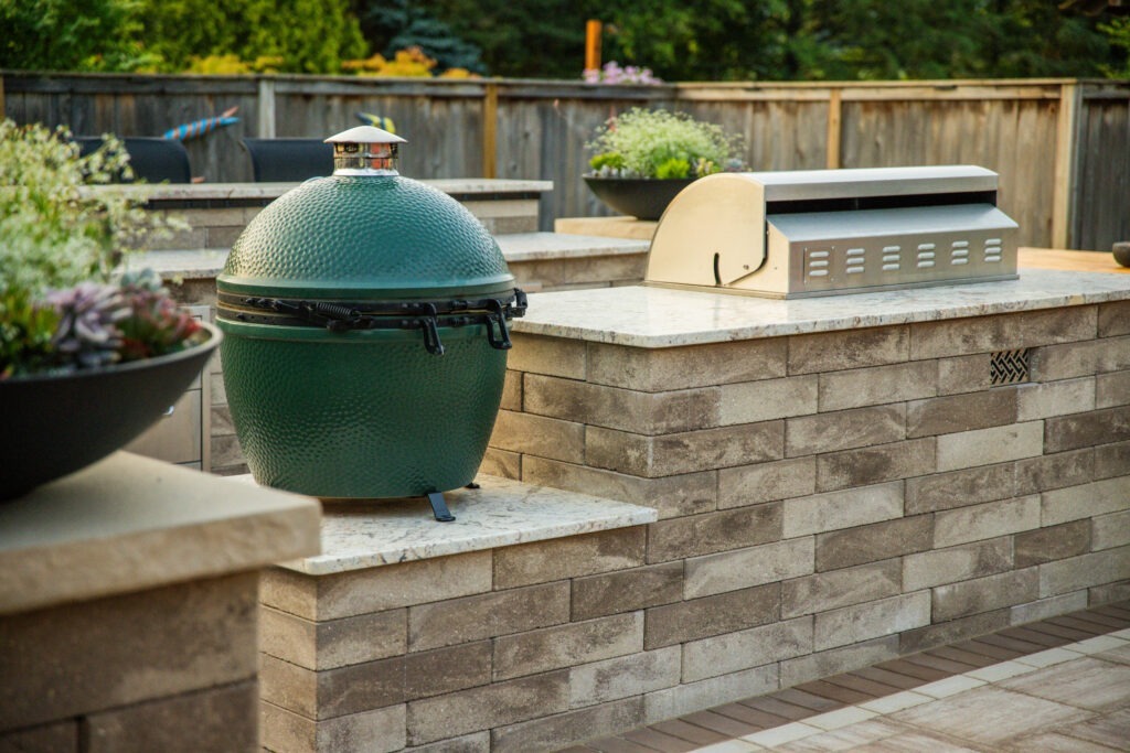 A fully equipped outdoor kitchen with a built-in grill, counter space, and seating.