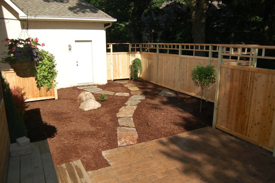 Low-maintenance landscaping with stone path and evergreen plantings Low-Maintenance Landscaping