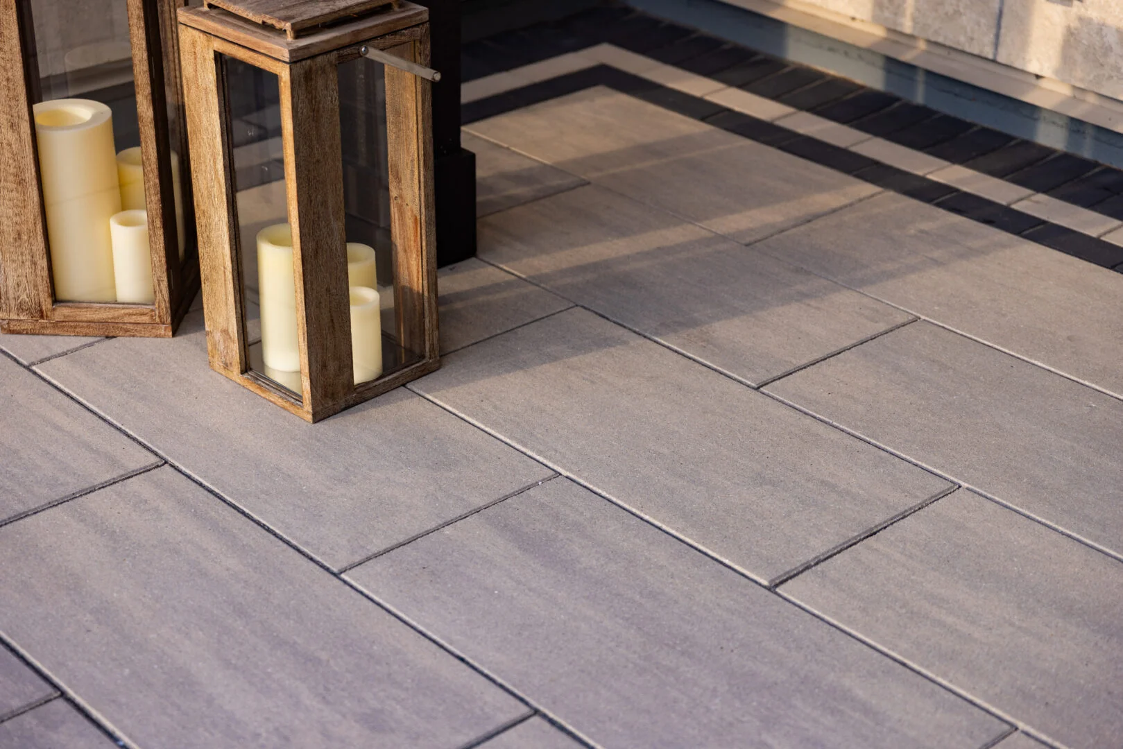 A close-up of Grand Discover XL pavers in Allure, showcasing natural lighting and shadows that enhance texture and depth in a Hudson, WI outdoor space.